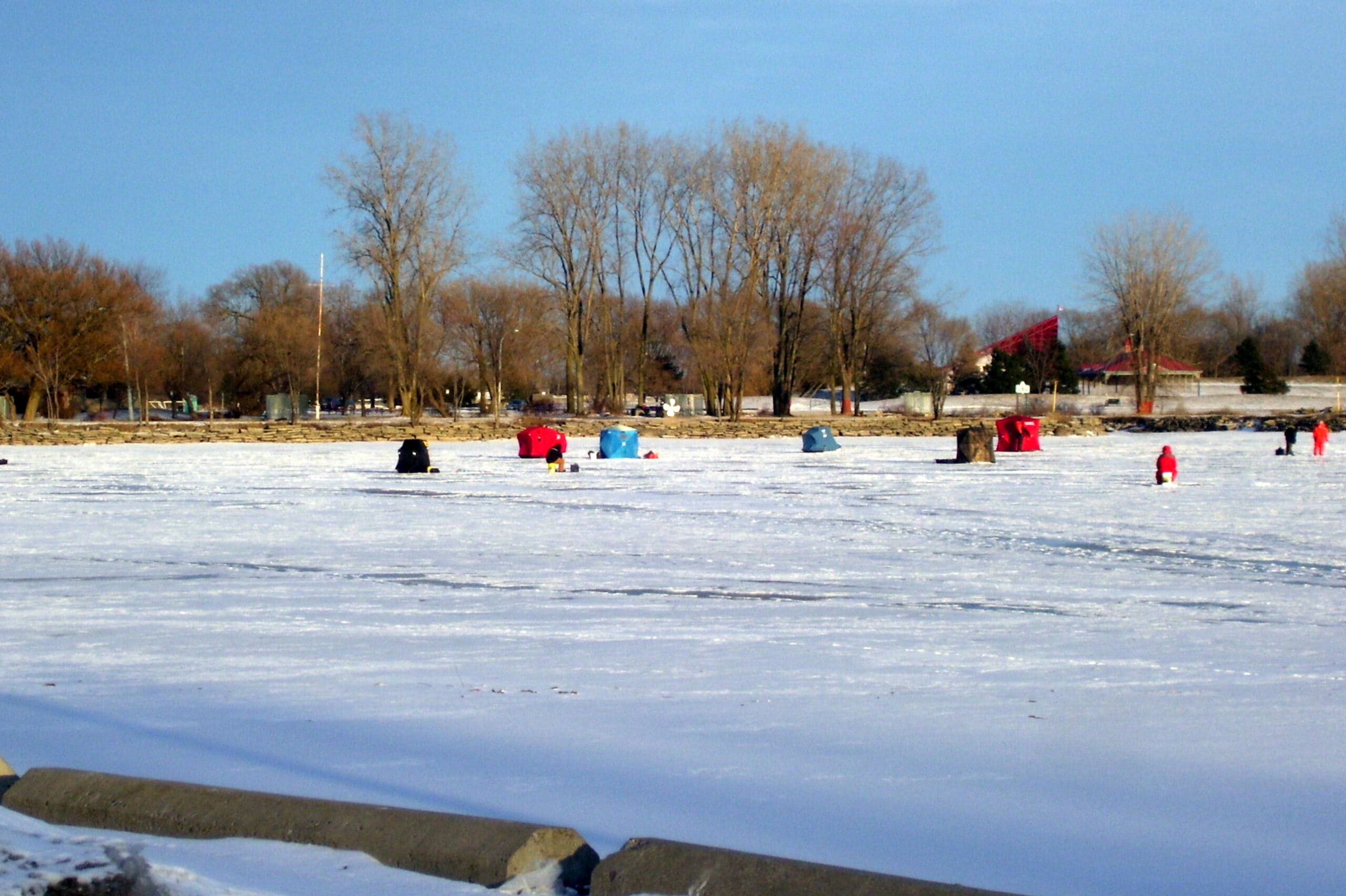 Photo of ice huts on the Bay of Quinte taken from the parking lot