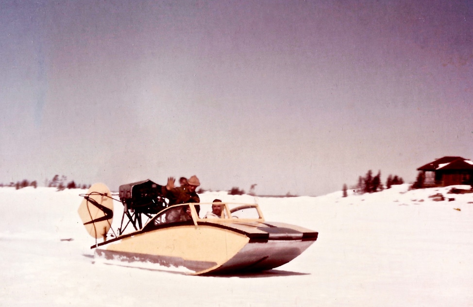 An old-timey photo of an unmanned scoot sitting on snow.